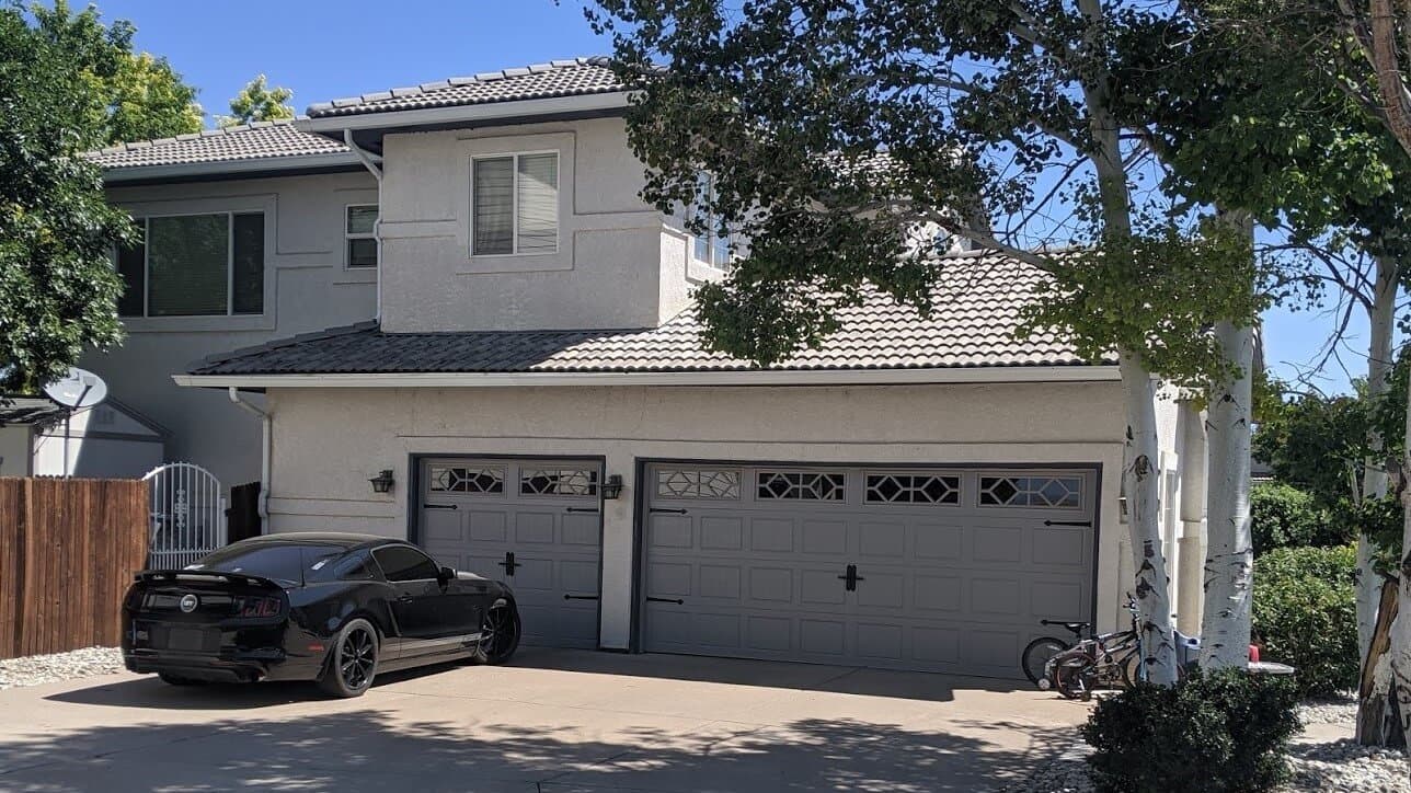 Gray carriage-style garage doors with diamond windows installed near Colorado City
